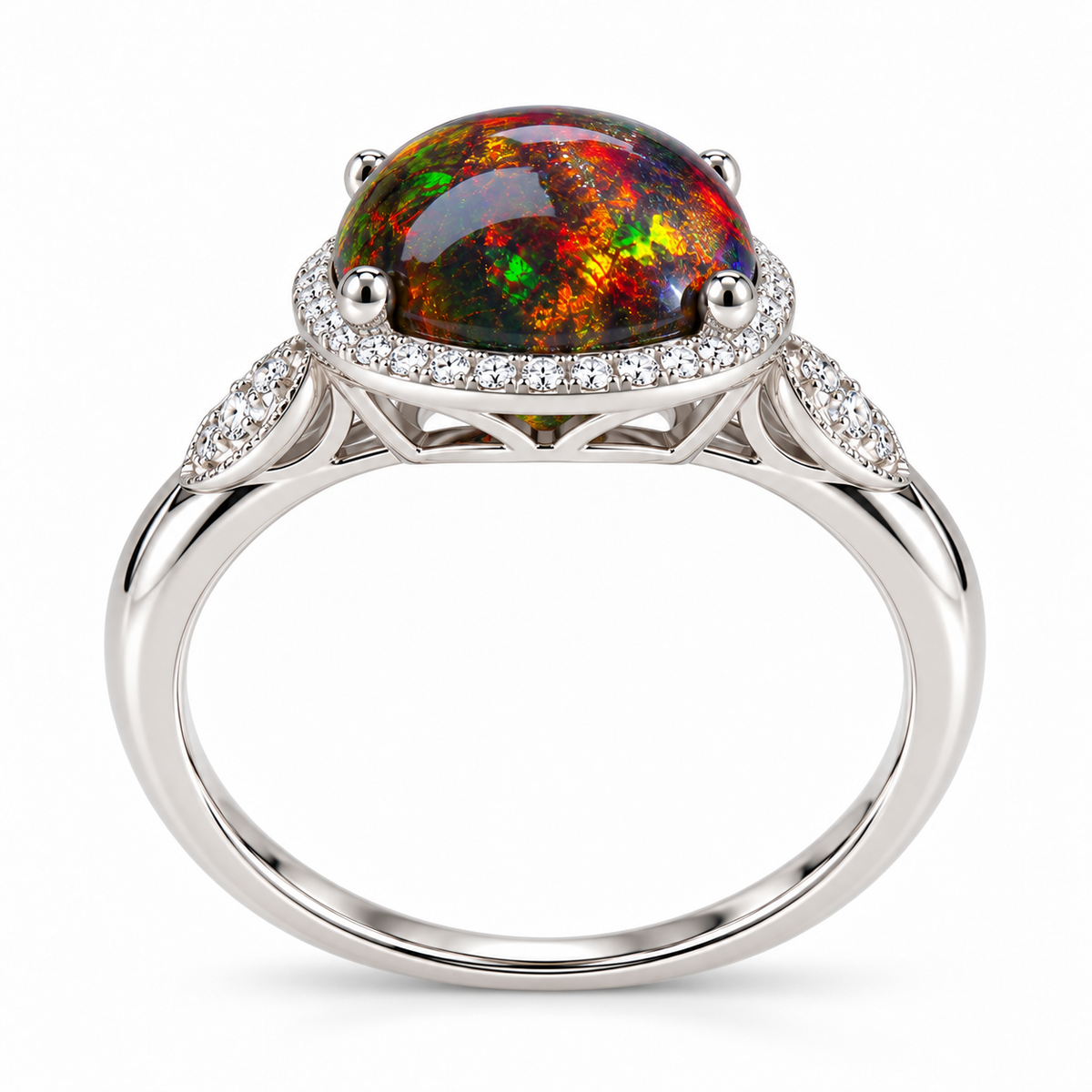 A silver-toned oval opal ring with a vibrant multicolor play-of-color center stone, surrounded by a halo of small clear stones and decorative shank details, set against a plain white background.