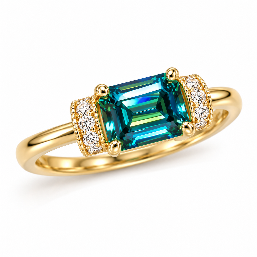 Three-quarter view of a 1 carat green moissanite ring featuring a 5x7mm east-west emerald-cut gemstone, polished gold-tone four-prong setting, and decorative cubic zirconia accent sections.
