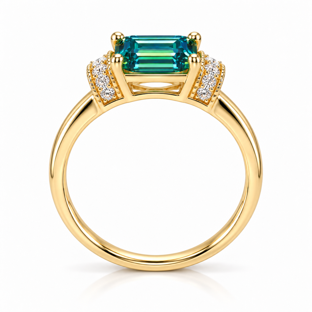 Side profile of a 1 carat lab-created green moissanite ring highlighting the 5x7mm emerald-cut gemstone, raised four-prong setting, decorative cubic zirconia shoulders, and polished gold-tone sterling silver band.