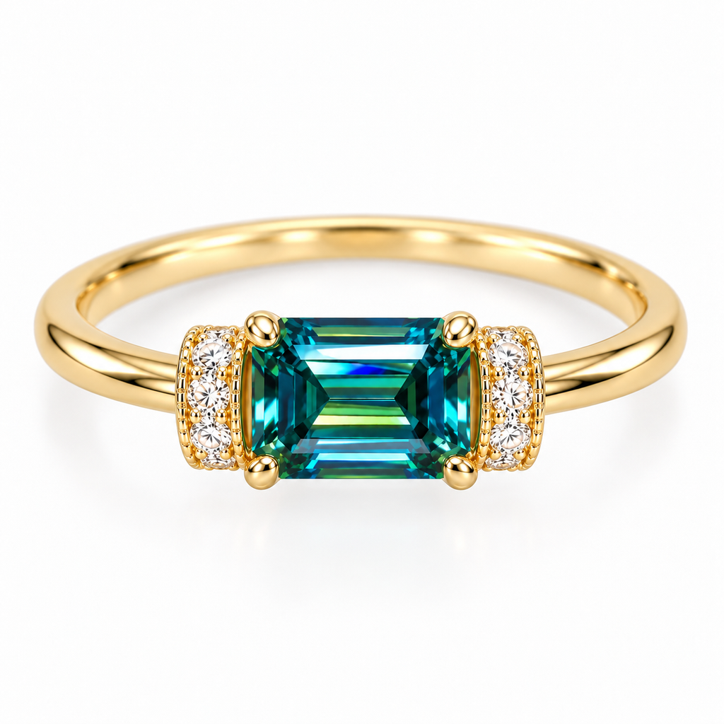 Top-down view of a 5x7mm emerald-cut green moissanite ring showing the horizontally positioned teal-green gemstone, symmetrical cubic zirconia accents, and polished Gold Plated sterling silver band.