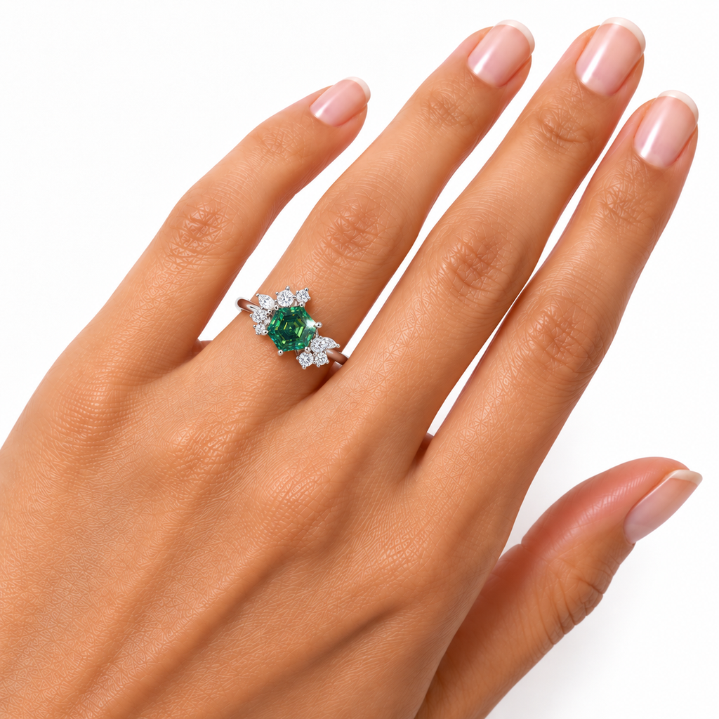 1 carat lab-created green moissanite ring worn naturally on a woman's ring finger, featuring a 6mm hexagon-cut gemstone with emerald-green and teal reflections, sparkling floral cubic zirconia accents, and a Platinum Plated 925 sterling silver band.