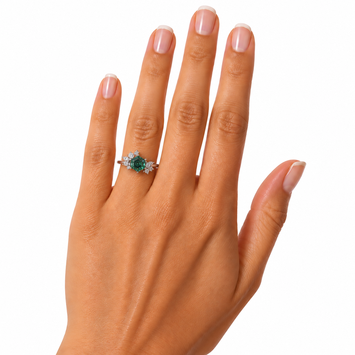 Angled close-up of a woman's hand wearing a 6mm hexagon-cut green moissanite ring, showcasing the gemstone's rich forest-green color, delicate asymmetrical floral cubic zirconia setting, and polished sterling silver band.