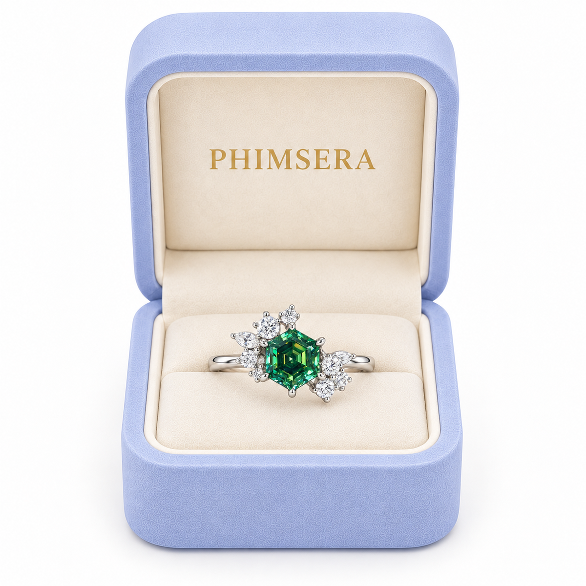 1 carat lab-created green moissanite hexagon ring displayed inside a periwinkle Phimsera jewelry box with ivory velvet interior and gold PHIMSERA lettering, featuring a 6mm emerald-green gemstone and sparkling floral cubic zirconia accents.