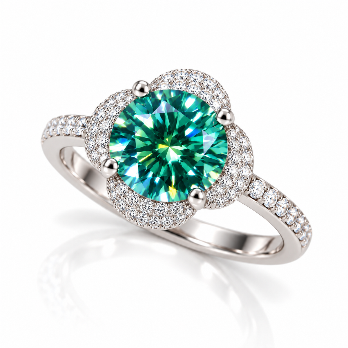 Three-quarter angle of a 2 carat round brilliant green moissanite ring showcasing the 8mm teal-green gemstone, delicate four-petal floral halo, sparkling clear cubic zirconia accents, and polished sterling silver band against a white background.