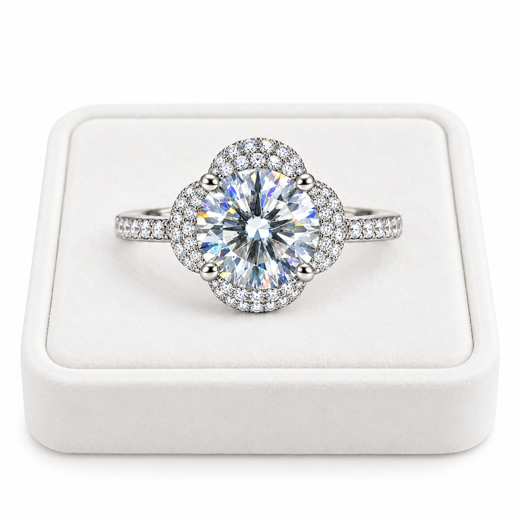 2 carat round brilliant white moissanite floral halo ring displayed on a premium white velvet jewelry tray with a pure white background, featuring a brilliant 8mm center gemstone and sparkling sterling silver setting.