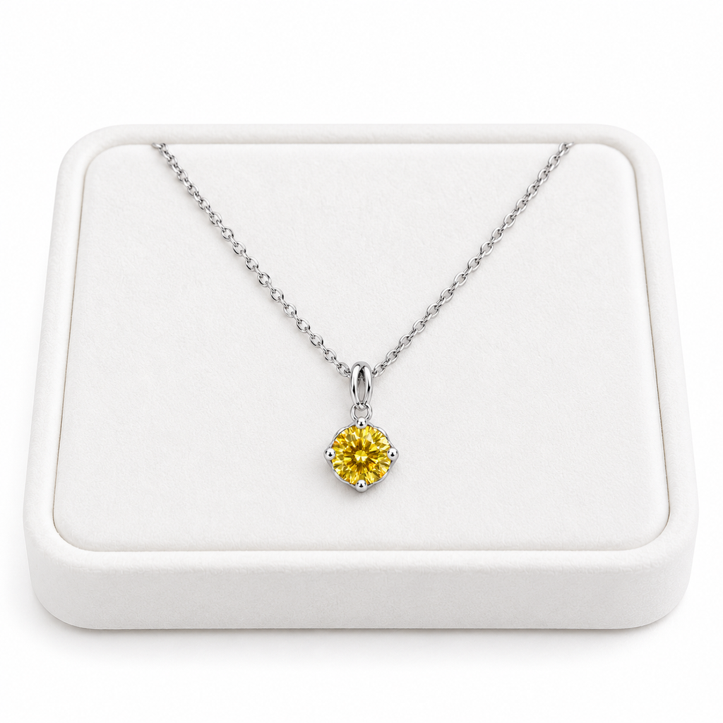 2 carat yellow moissanite solitaire necklace arranged on a premium white velvet jewelry tray with a delicate sterling silver chain and brilliant 8mm golden-yellow round gemstone against a pure white background.