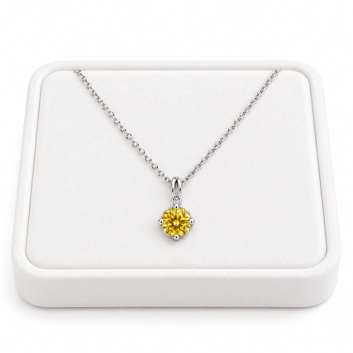 2 carat yellow moissanite solitaire necklace arranged on a premium white velvet jewelry tray with a delicate sterling silver chain and brilliant 8mm golden-yellow round gemstone against a pure white background.