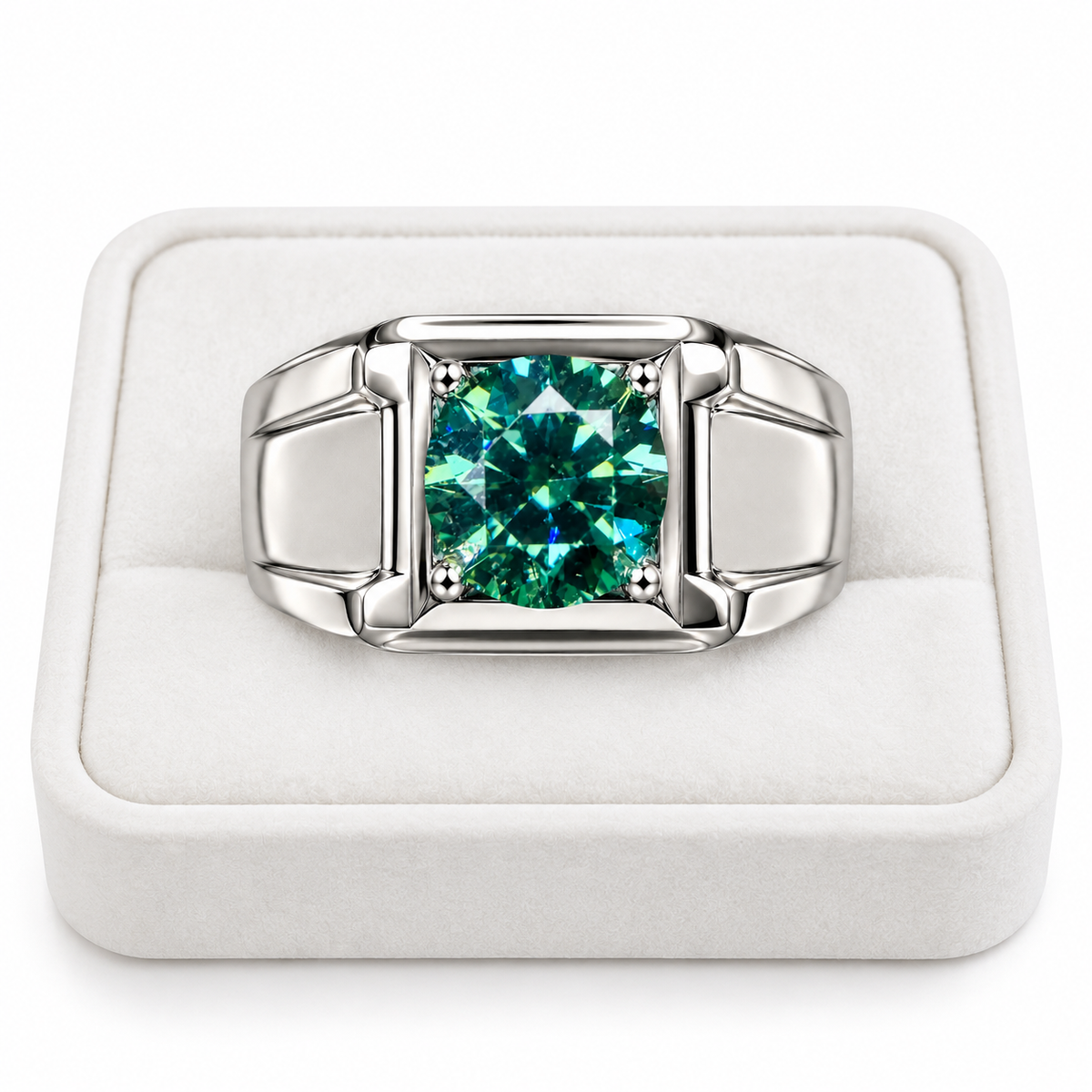 A silver-toned men's ring with a large square-cut green gemstone, displayed in a white velvet ring box.
