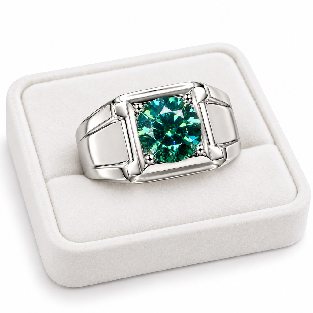 A silver-toned men's ring with a square bezel setting holding a vibrant green marquise-cut gemstone, presented in a white velvet ring box.