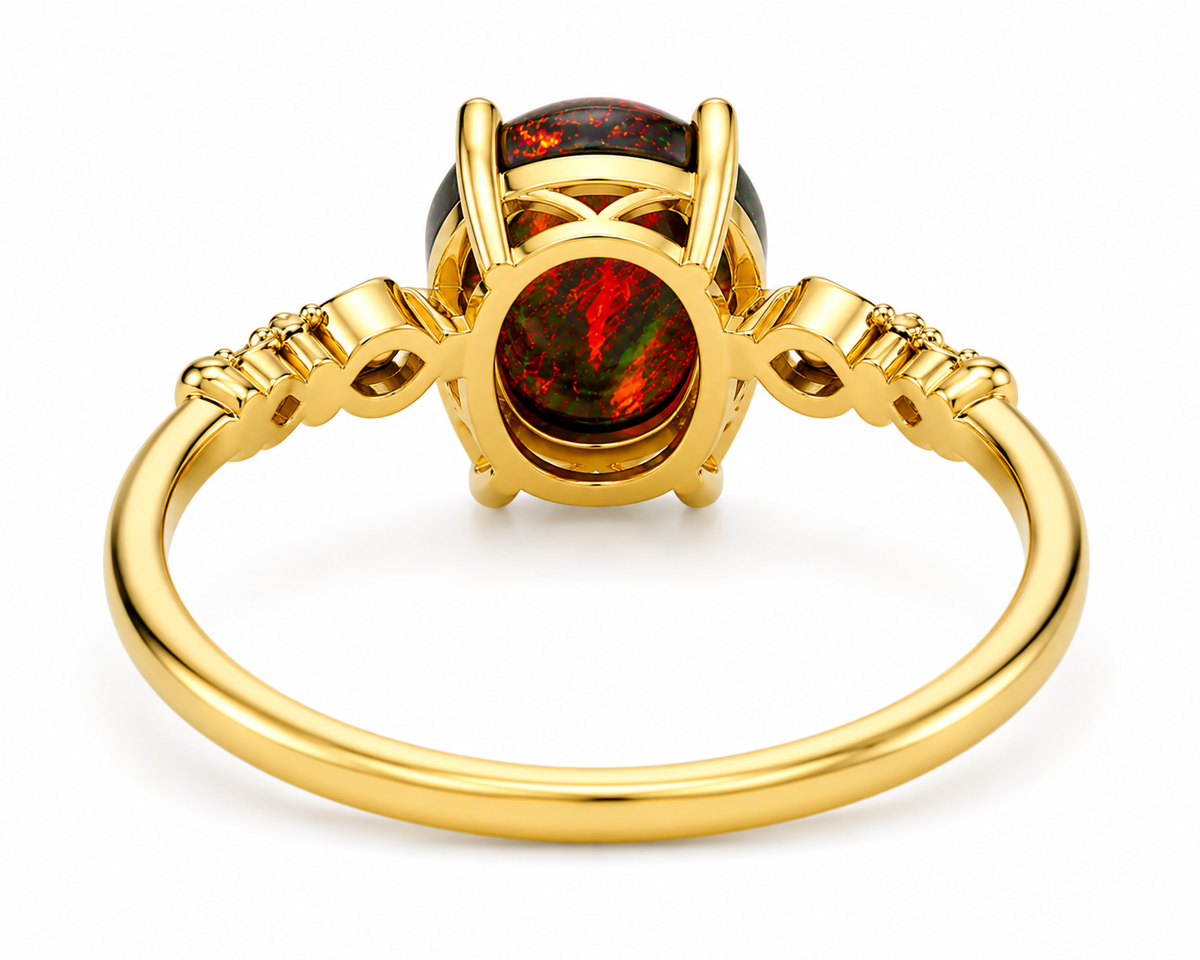 Australian Black Fire Opal ring featuring a 3 CT 8x10mm oval Australian opal with brilliant red fire in a sterling silver setting with gold plating and decorative shoulders.