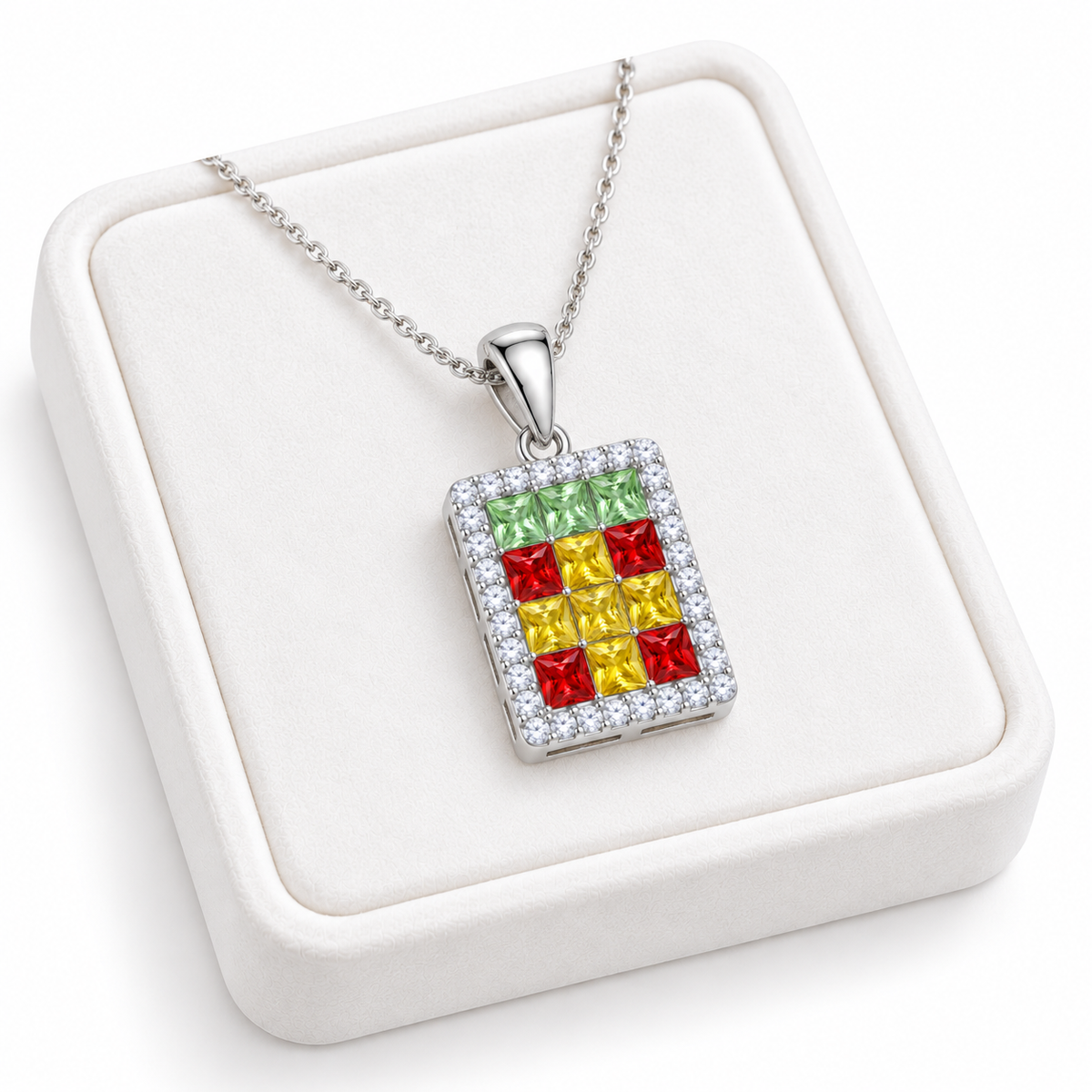 Multicolor gemstone pendant necklace displayed on a white velvet jewelry tray