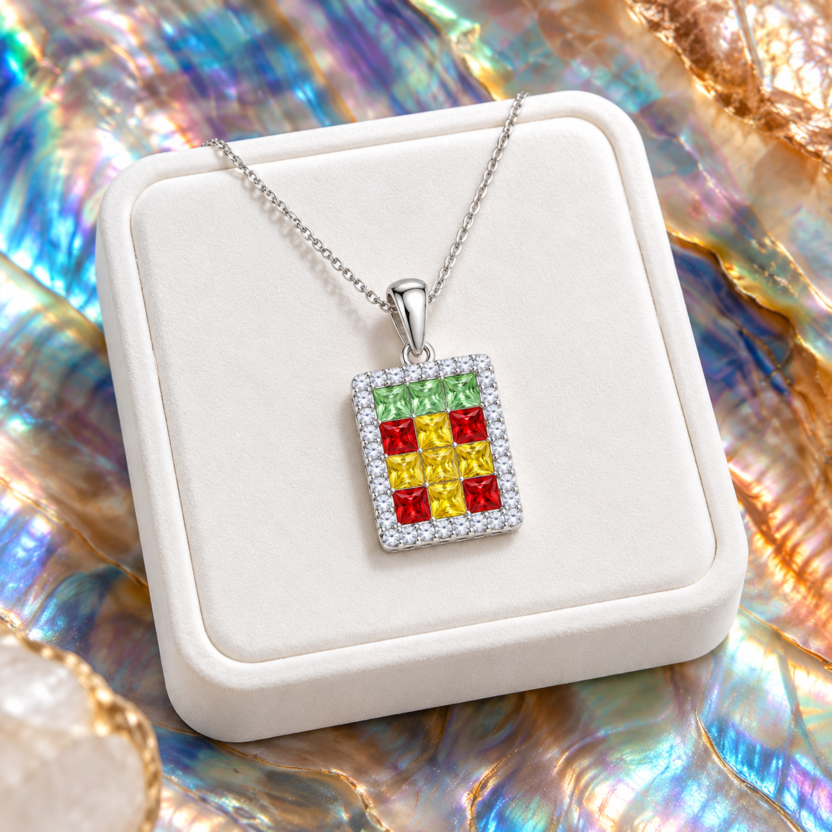 Angled multicolor gemstone pendant necklace on white velvet with colorful iridescent backdrop