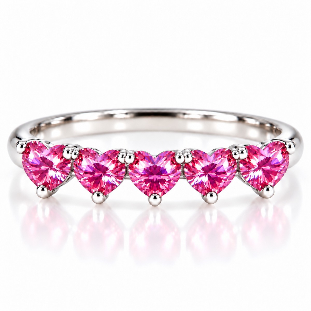 Five matching 4mm heart-cut pink moissanite stones on a curved 925 sterling silver ring