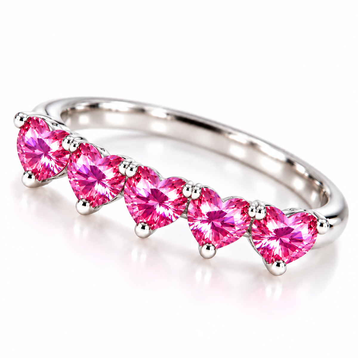 Angled view of five matching 4mm heart-cut pink moissanite gemstones on a curved silver ring