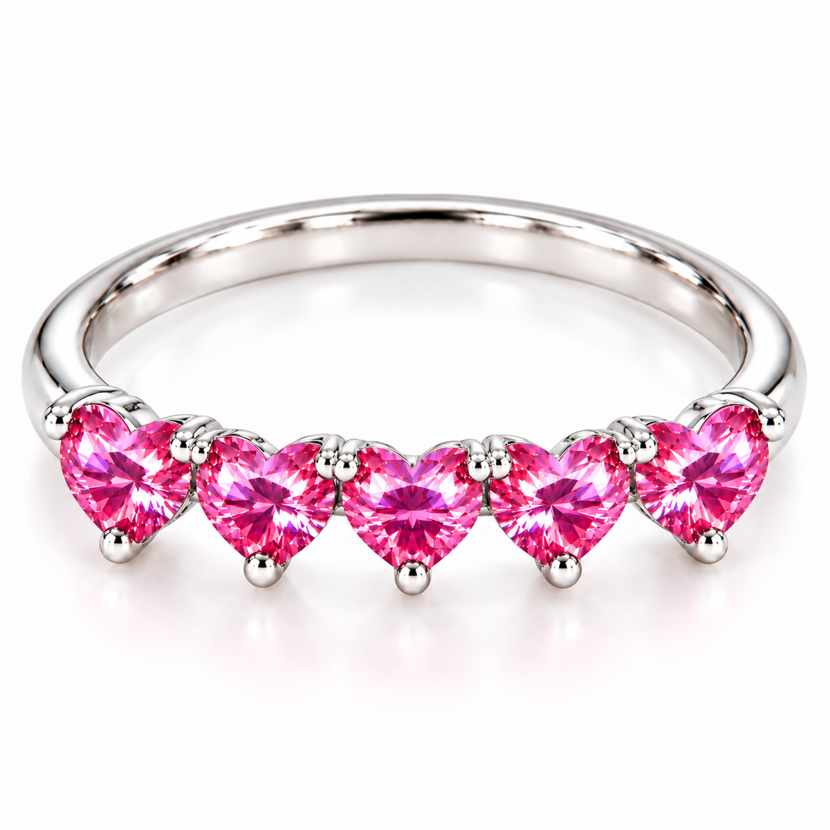 Elevated view of five matching 4mm heart-cut pink moissanite gemstones on a sterling silver ring
