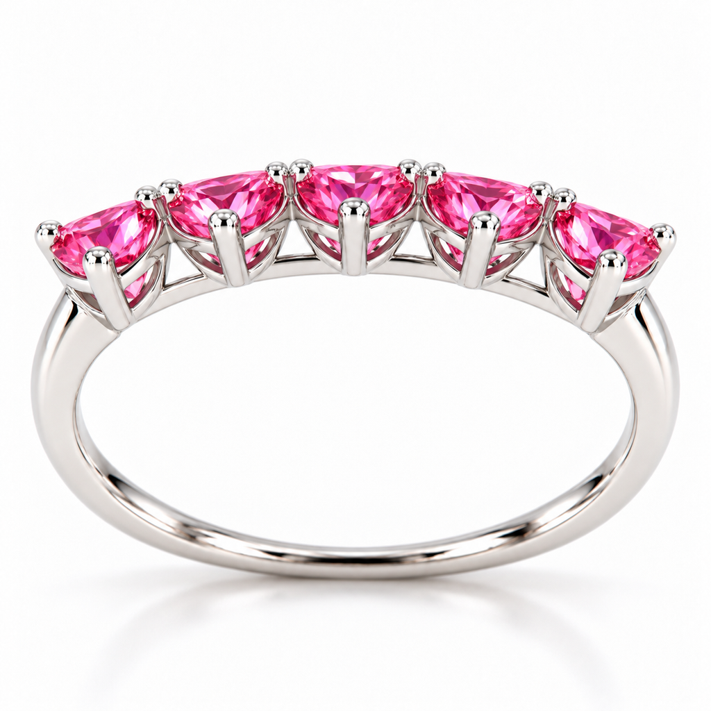 Side view of five 4mm heart-cut pink moissanite gemstones on a curved sterling silver ring