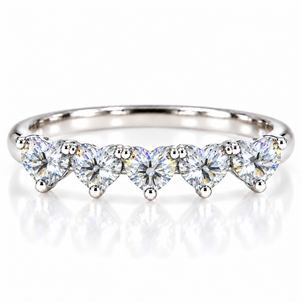 Five matching 4mm heart-cut white moissanite stones on a curved 925 sterling silver ring