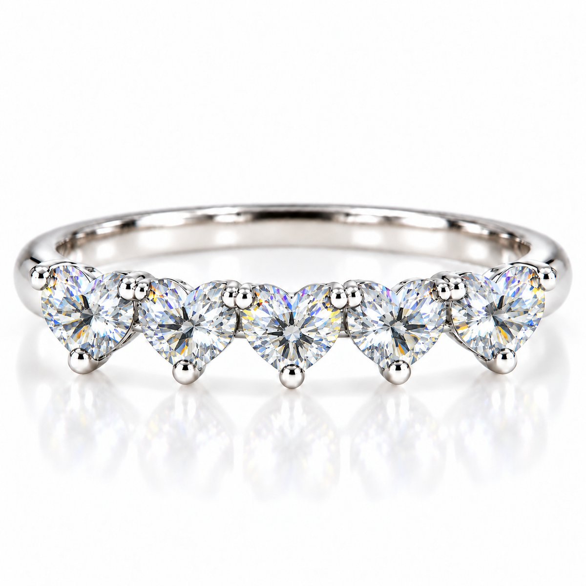 Five matching 4mm heart-cut white moissanite stones on a curved 925 sterling silver ring