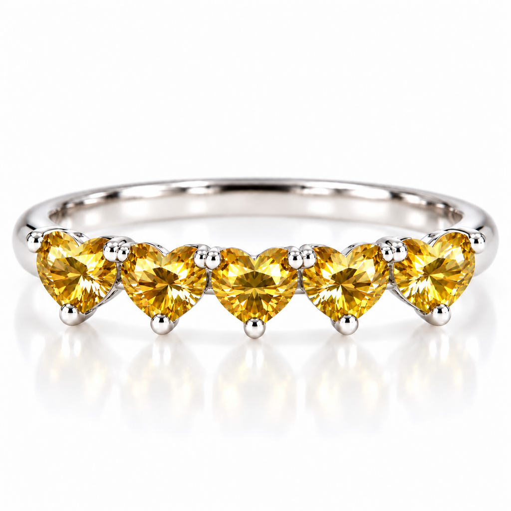 Five matching 4mm heart-cut yellow moissanite stones on a curved 925 sterling silver ring