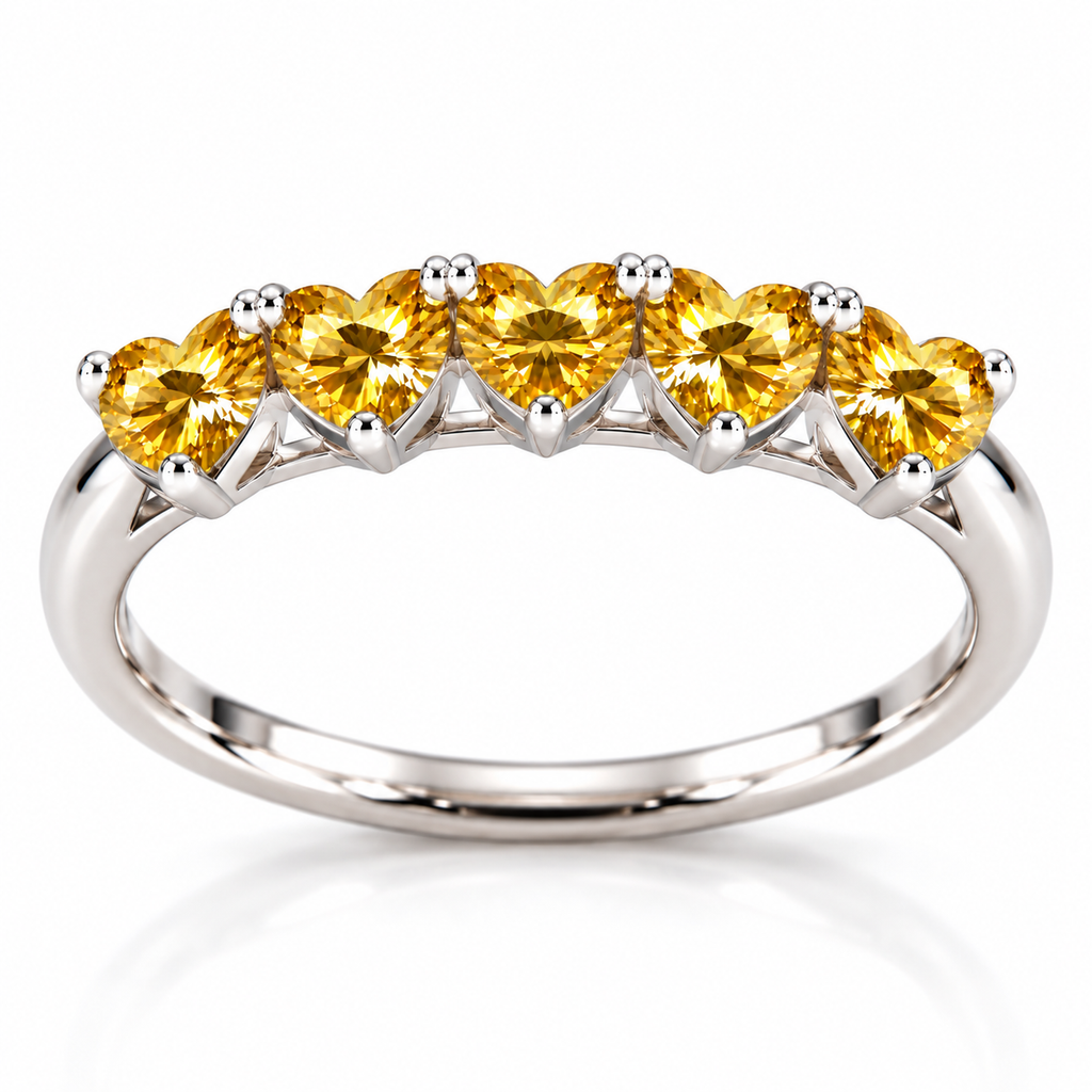 Side view showing five 4mm heart-cut yellow moissanite gemstones and the curved sterling silver ring band