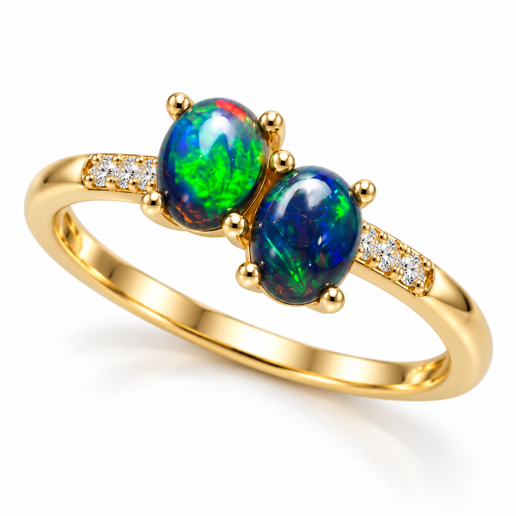 Angled view of a 4x5mm black fire opal two-stone ring featuring two offset oval cabochon gemstones, polished Gold Plated sterling silver, and clear cubic zirconia shoulder accents.