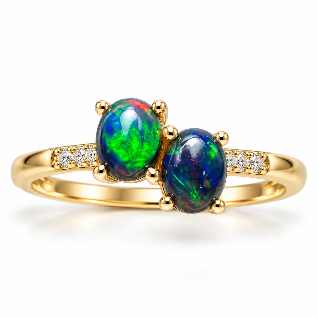 Black fire opal two-stone ring featuring two 4x5mm oval gemstones with vibrant green and blue flashes, Gold Plated sterling silver band, and sparkling cubic zirconia accents on a white background.