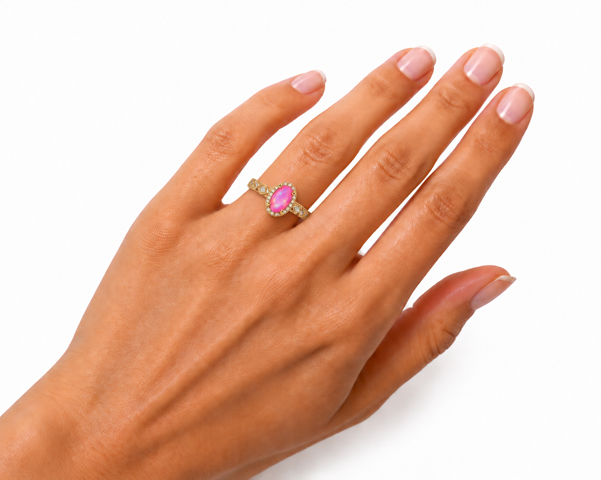 4x8mm dyed pink Australian fire opal halo ring worn on a woman's ring finger, showing its petite gemstone proportions and detailed Gold Plated zigzag band.