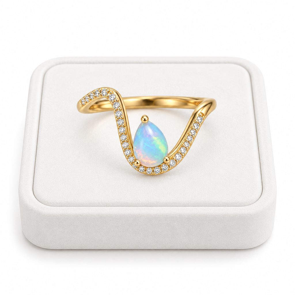 5x7mm pear shaped natural opal ring displayed on a white jewelry tray