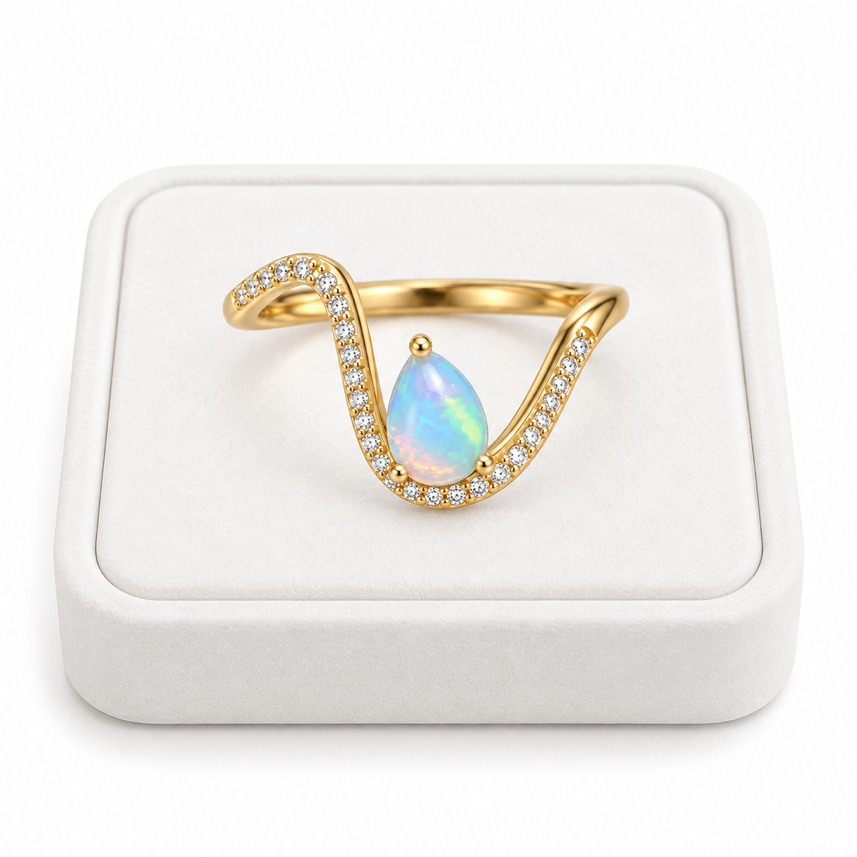 5x7mm pear shaped natural opal ring displayed on a white jewelry tray