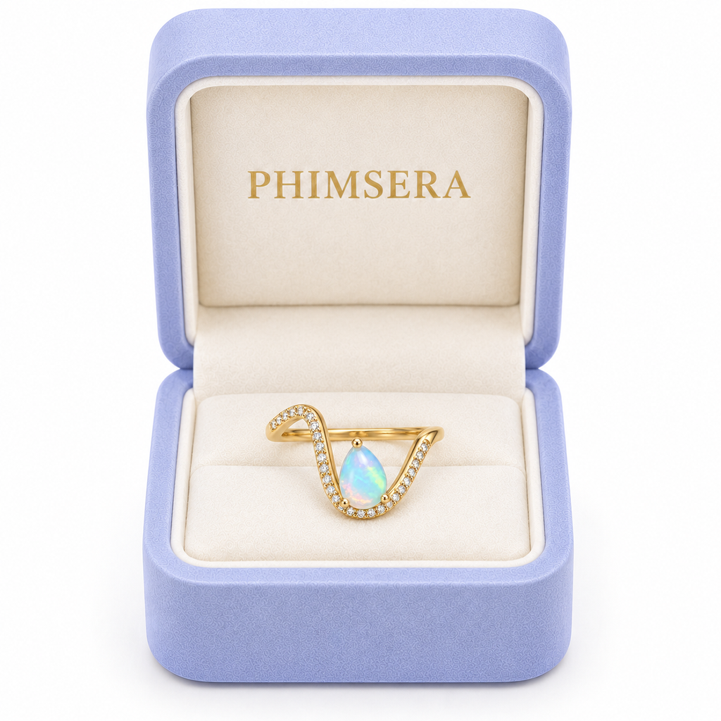 Phimsera 5x7mm natural pear shaped opal ring presented inside a lavender jewelry box