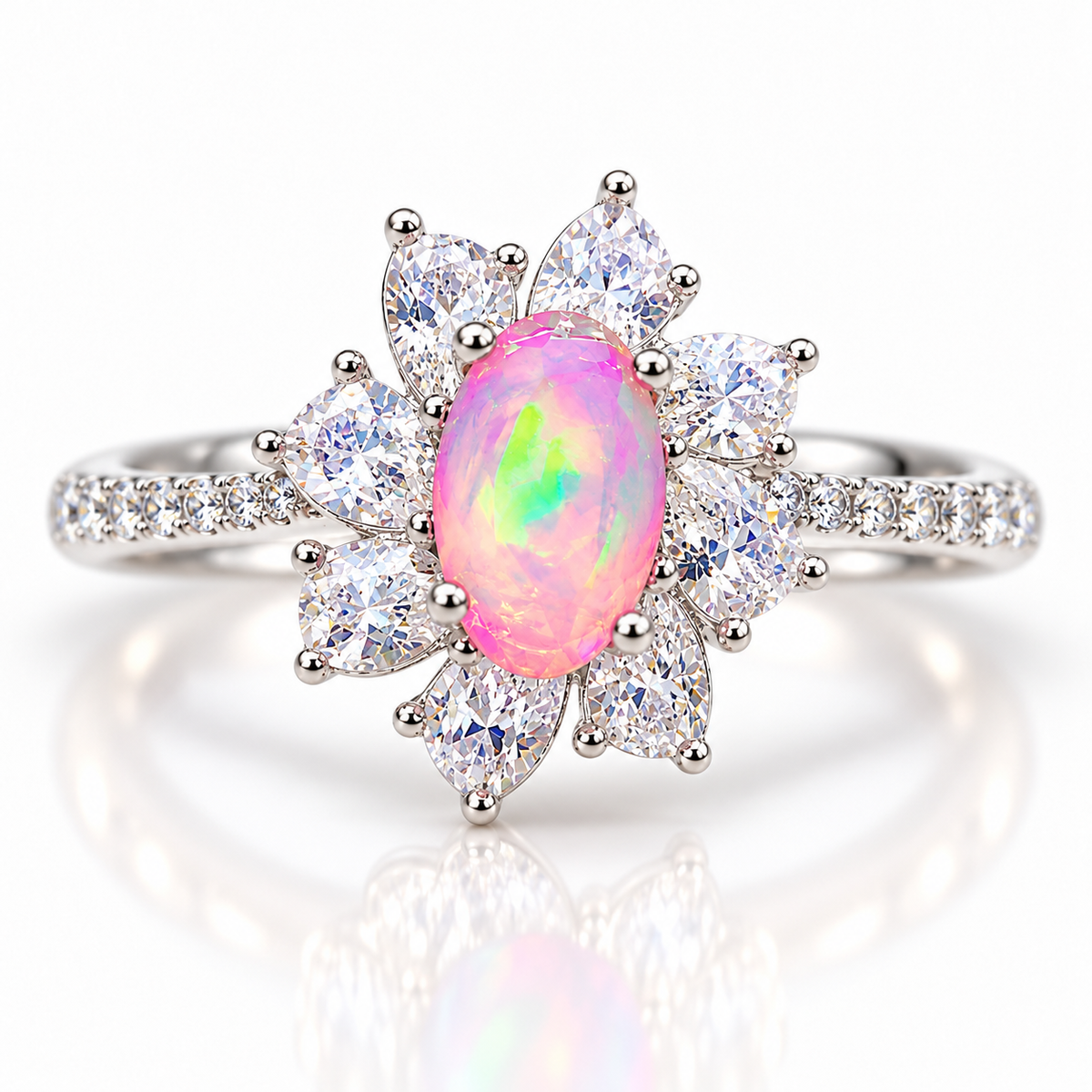 Australian pink fire opal flower ring featuring a 5x8mm oval natural white opal dyed pink, surrounded by eight pear-shaped cubic zirconia petals in Platinum Plated sterling silver on a white background.