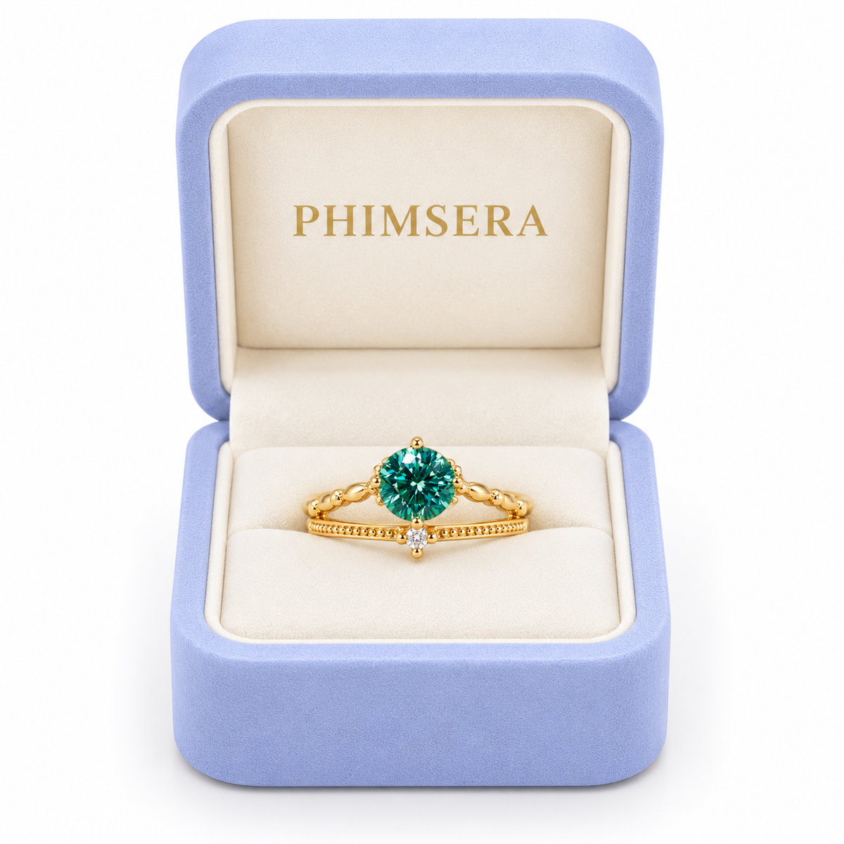 6.5mm round brilliant green moissanite ring displayed inside a periwinkle Phimsera jewelry gift box with an ivory interior and gold PHIMSERA lettering, showcasing the vibrant teal-green gemstone, elegant Gold Plated sterling silver band, and delicate cubic zirconia accent against a white background.