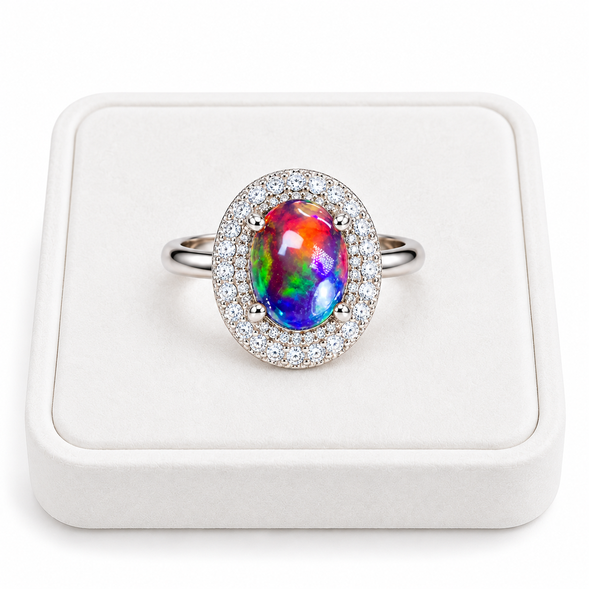 Australian black fire opal double halo ring featuring a 6x8mm oval gemstone displayed on a flat white velvet jewelry tray against a clean white background.
