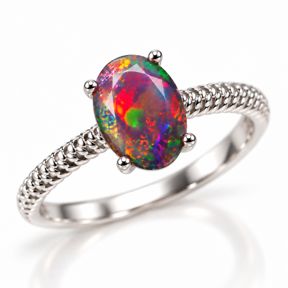 Three-quarter view of a 6x8mm Australian black fire opal ring with colorful oval gemstone, polished four-prong setting, and symmetrical textured shoulders in Platinum Plated sterling silver.