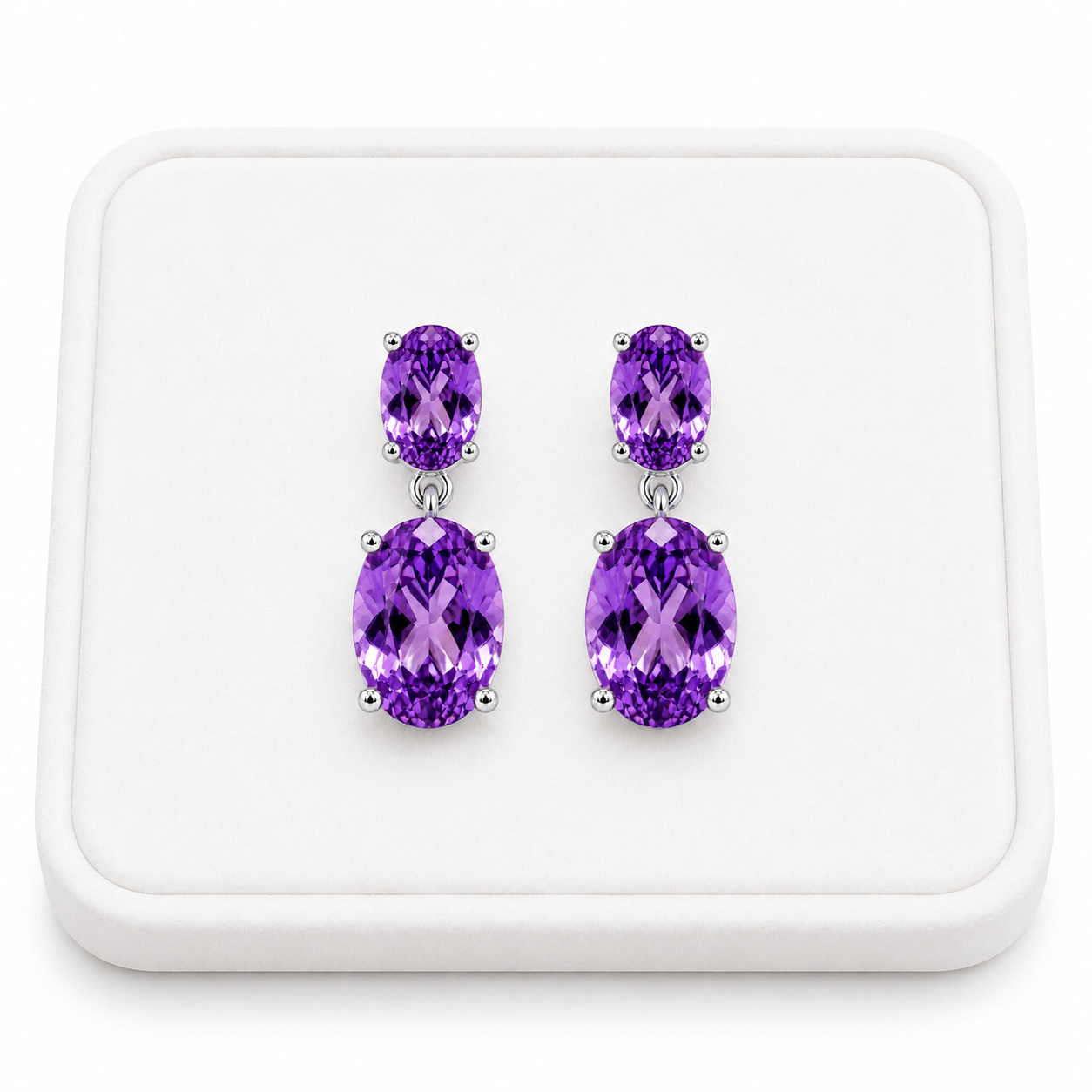 Natural Amethyst dangle earrings displayed on a white velvet jewelry tray