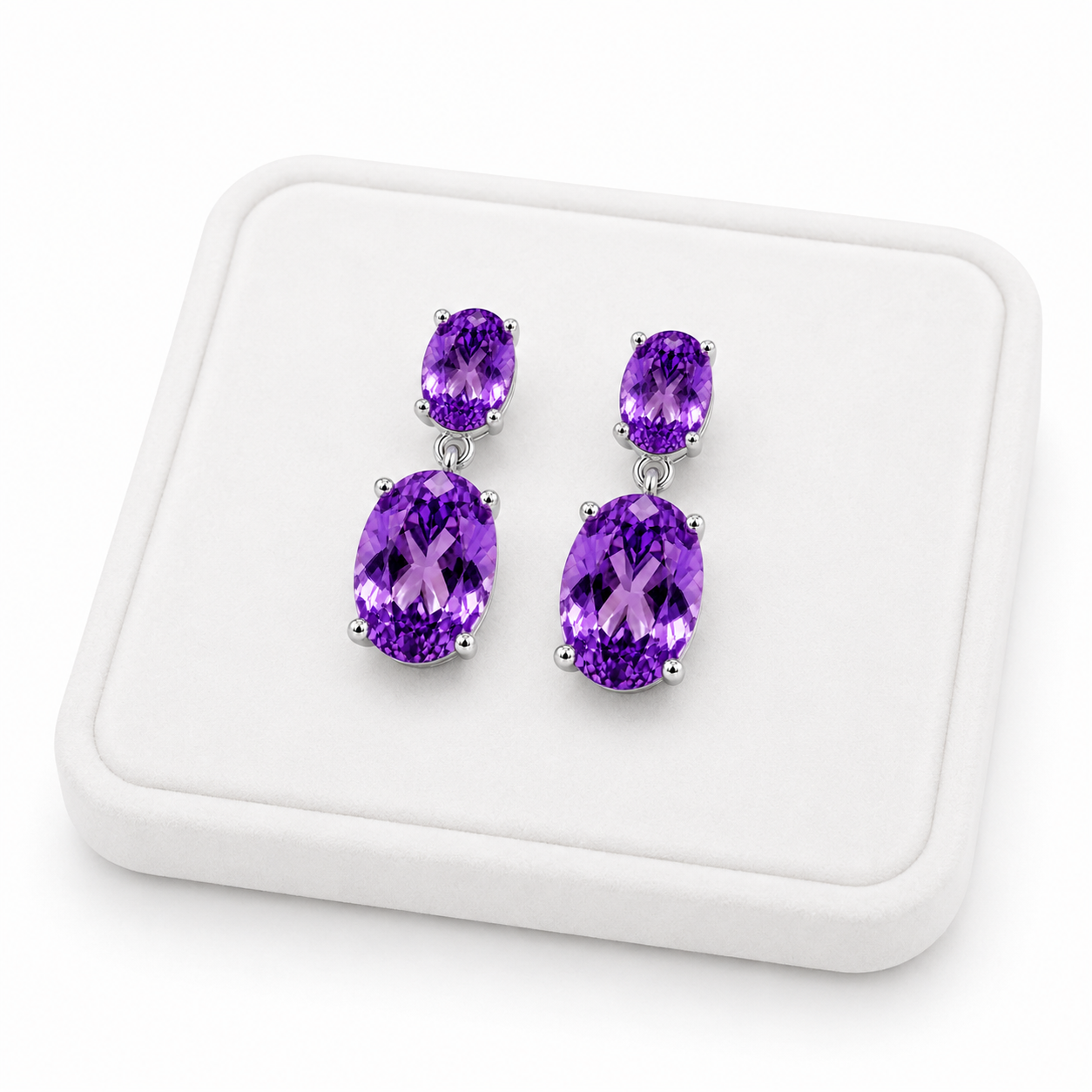 Natural Amethyst dangle earrings displayed on a white velvet jewelry tray