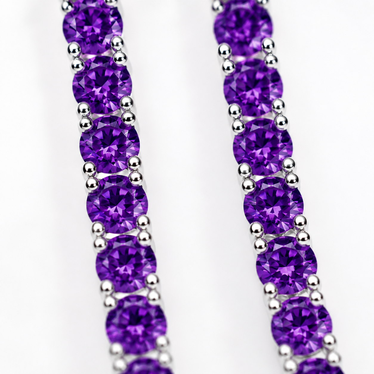 Macro view of 3mm round purple amethyst gemstones in Phimsera sterling silver dangle earrings