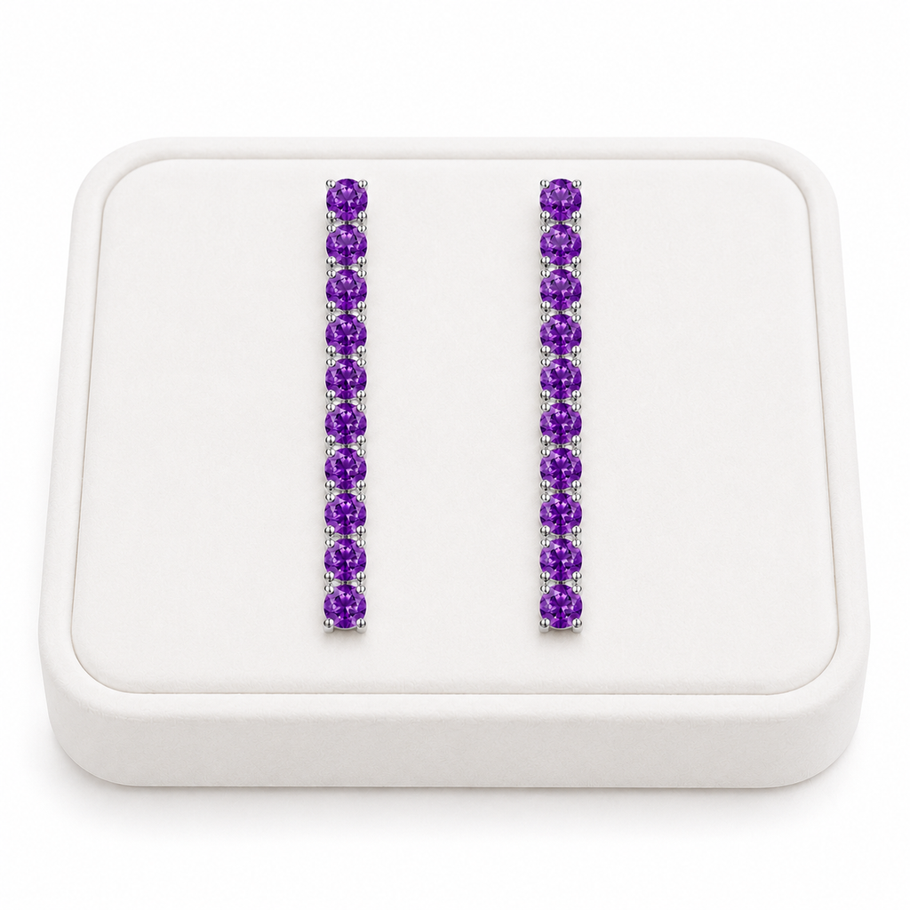 Phimsera natural amethyst dangle earrings displayed on a white velvet jewelry tray against a bright white background