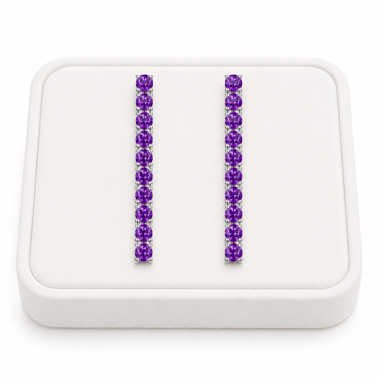 Phimsera natural amethyst dangle earrings displayed on a white velvet jewelry tray against a bright white background