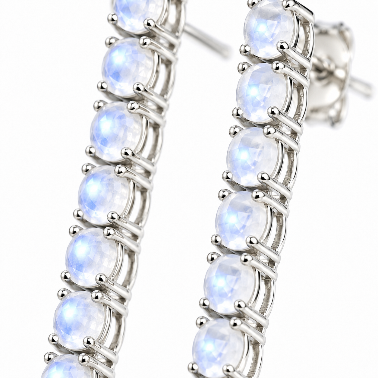 Macro view of natural 3mm round moonstone gemstones with a soft luminous appearance in Phimsera sterling silver earrings