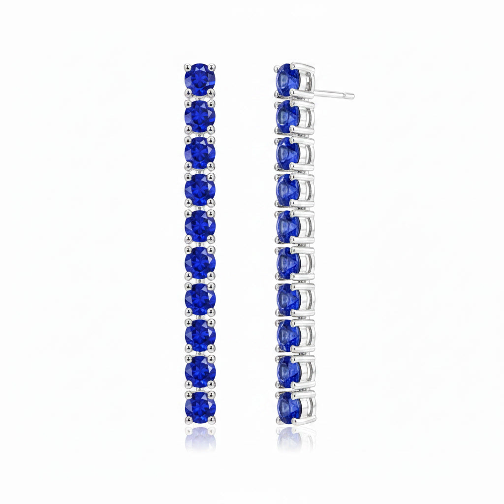 Close angled view of Phimsera 3mm round blue sapphire dangle earrings featuring 10 sapphires on each earring