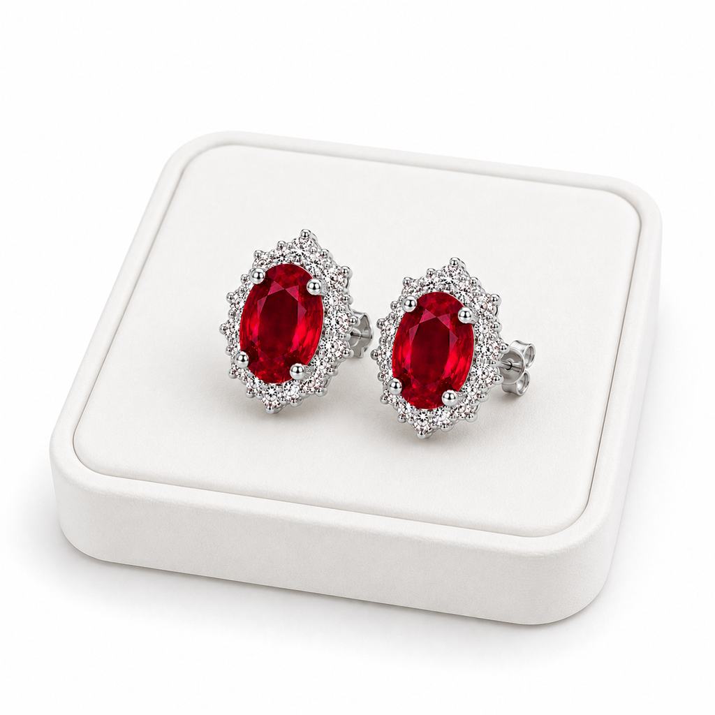 Natural ruby halo stud earrings displayed on white jewelry tray