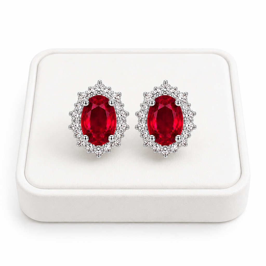 Natural ruby halo stud earrings displayed on white jewelry tray