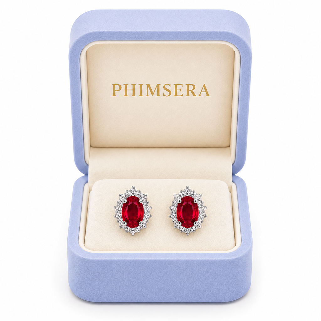 Natural 4x5mm ruby halo stud earrings displayed in Phimsera jewelry gift box