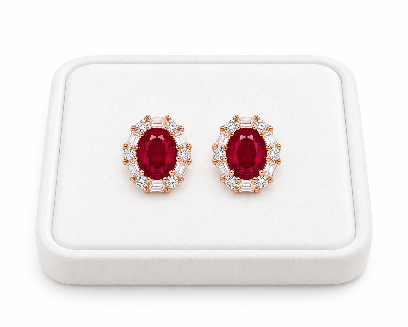 Natural 4x5mm ruby stud earrings displayed on a white jewelry tray
