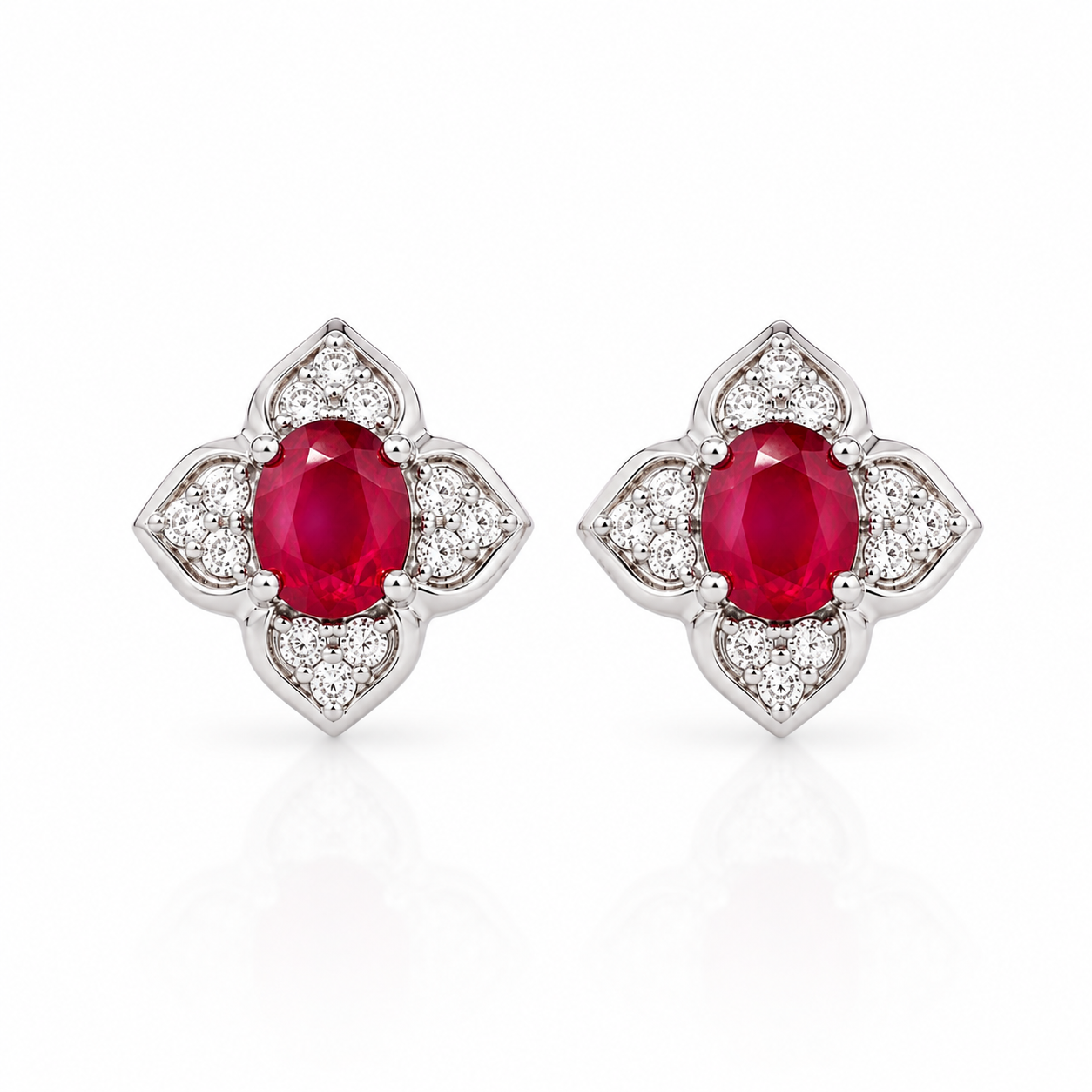Natural 4x5mm oval ruby floral stud earrings with CZ accents in 925 sterling silver front view