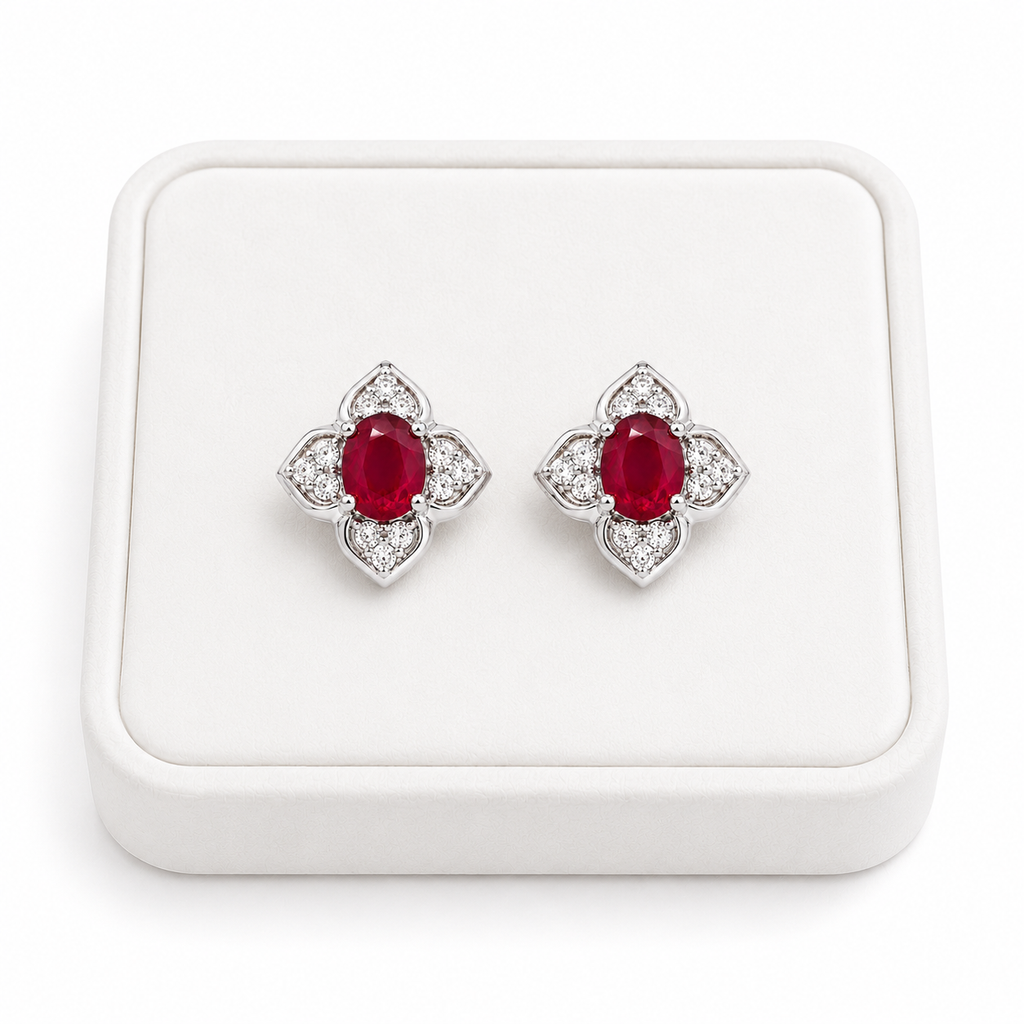 Natural ruby floral stud earrings displayed on a white jewelry tray