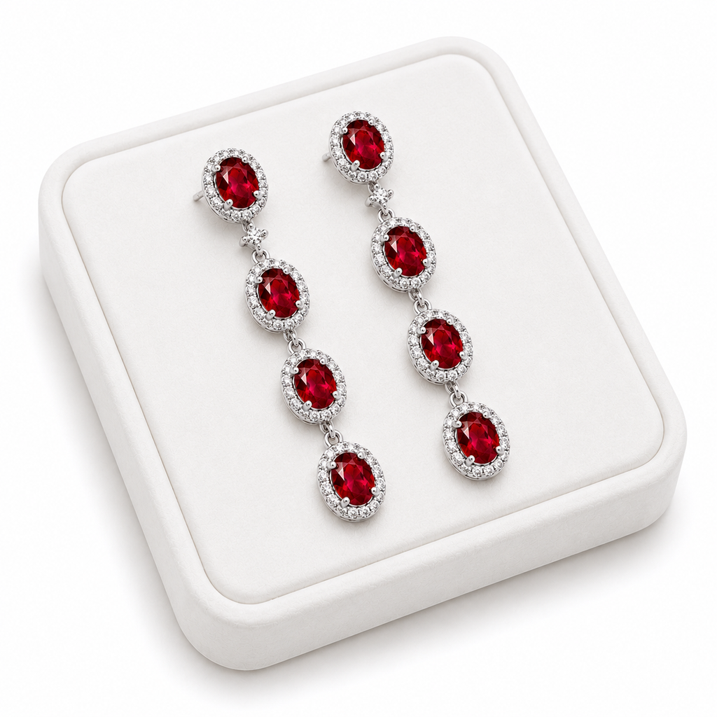 Natural ruby drop earrings displayed on white luxury jewelry tray