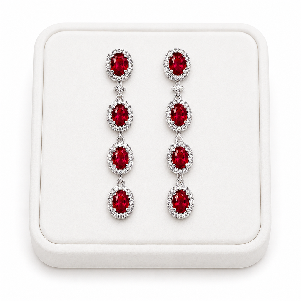 Natural ruby drop earrings displayed on white luxury jewelry tray