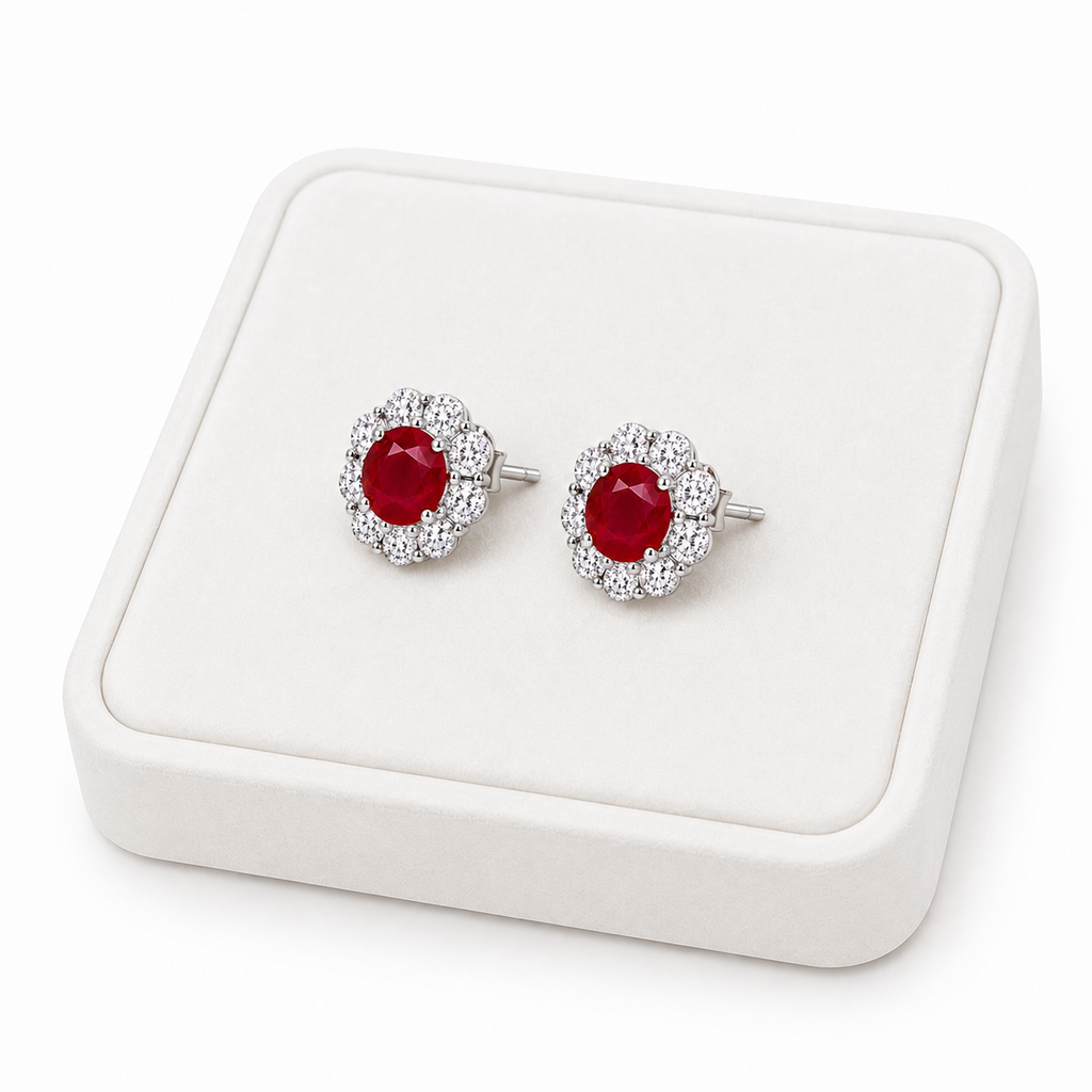 Natural ruby floral halo stud earrings displayed on white luxury jewelry tray